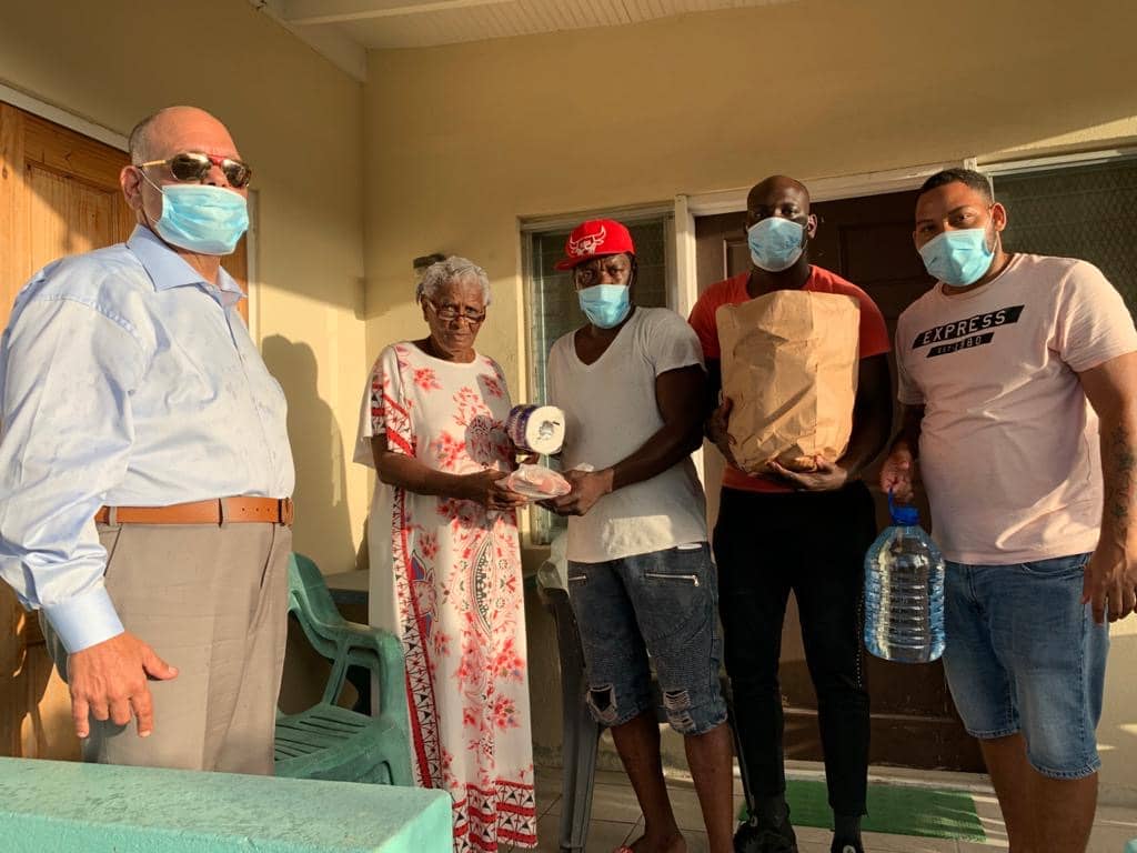 MP Asot Michael and volunteers on Sunday with Pares Resident Mrs. Shirley Butler