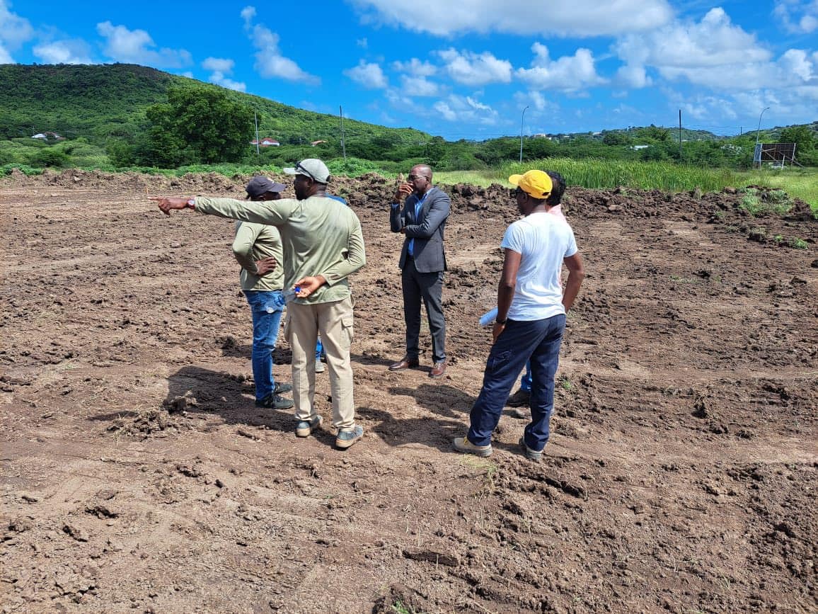 minister matthew on site of five islands primary school