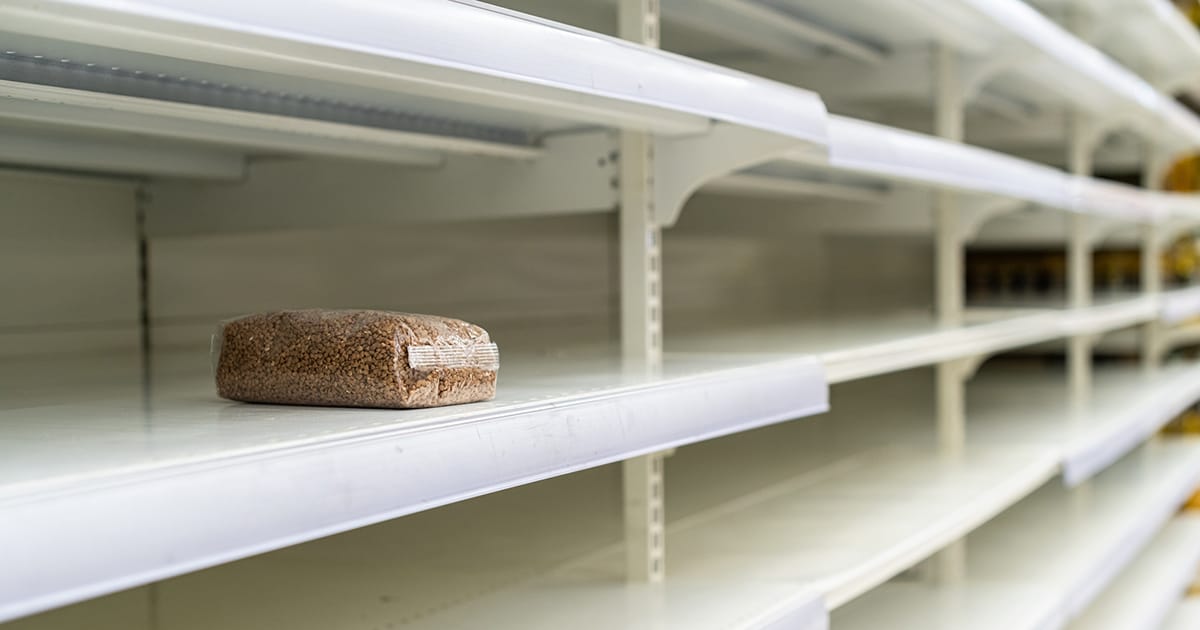 Shopping during virus outbreak. One packet of buckwheat on empty supermarket shelves. grocery store. pandemic. coronavirus. The concept of crisis and food shortages