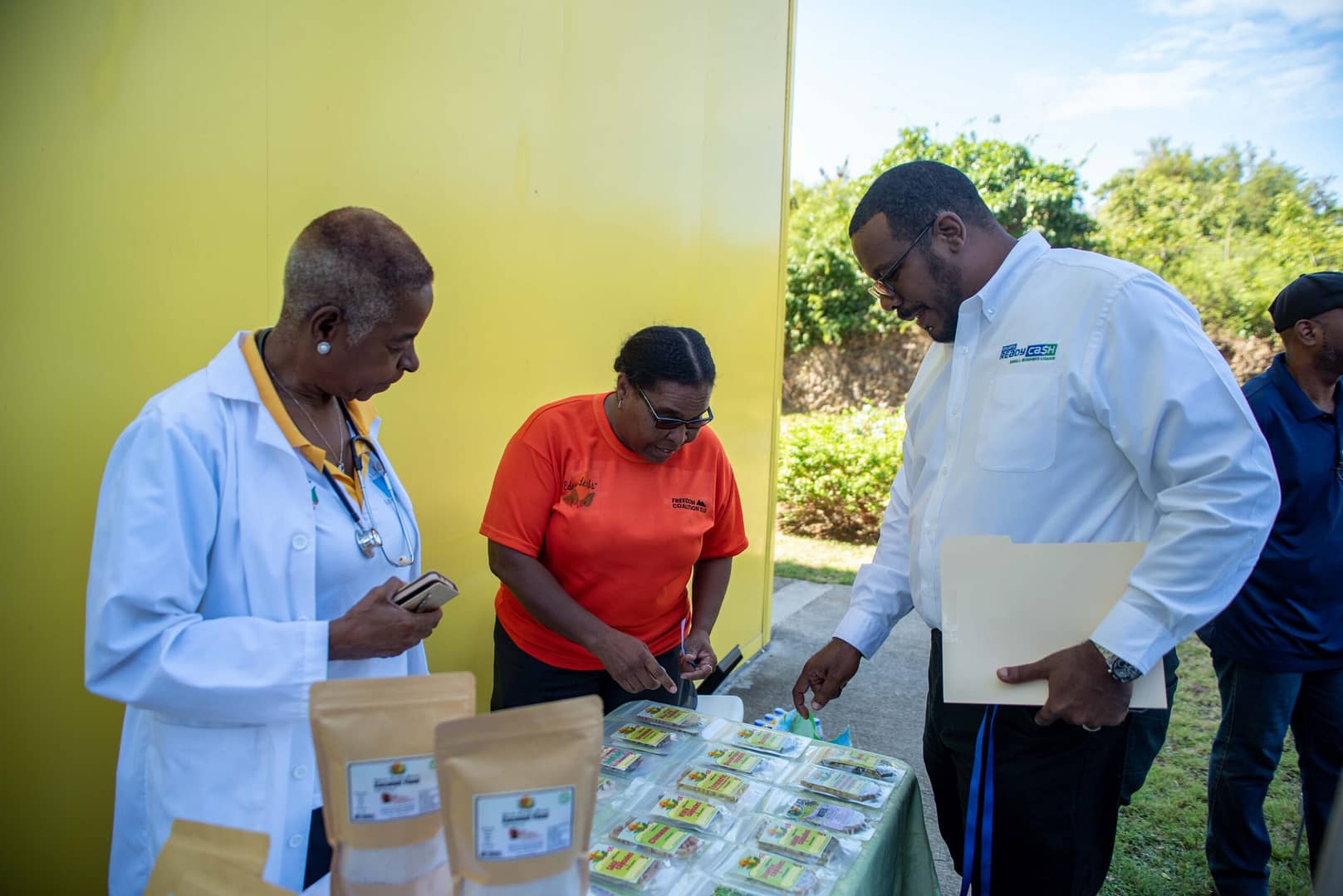 (right) Johnathan Johannes- Managing Director Unicomer OES viewing the Eden Herbs and Foods Display with (left)Dr Gilbertha St Rose and (middle) Perpetua Albert