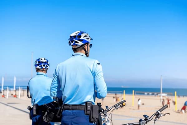 two-policeman-patrolling-seaside-promenade-600nw-2159767107