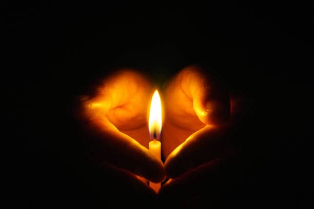 The hand that protects the candles in the dark.