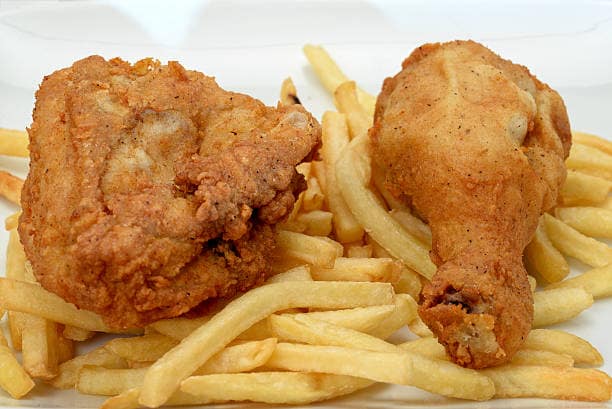 Southern fried chicken with french fries - studio shot